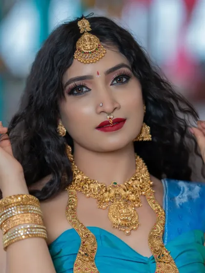 A close-up portrait showing the dramatic eye makeup and flawless skin.