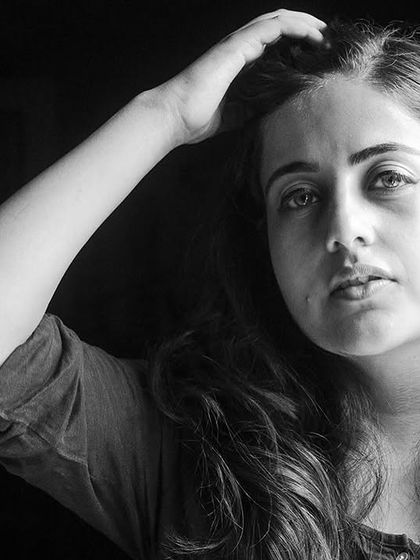 A high-contrast black and white portrait from the 'Ignite' series. The direct gaze and simple lighting create a powerful and honest image.