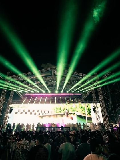 A stunning display of green lasers fanning out over the crowd from the stage during Black Coffee's performance.