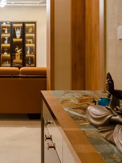 A serene corner featuring a Buddha statue, creating a peaceful and spiritual ambiance. We often incorporate such elements to bring a sense of calm and mindfulness into our designs.
