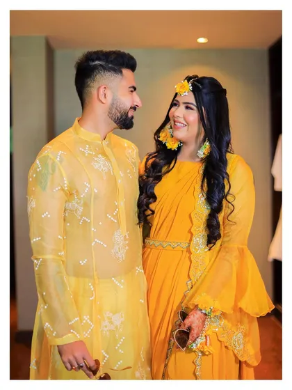 This portrait captures the happy couple during their Haldi ceremony. We focus on creating relaxed and natural couple portraits amidst the vibrant celebrations.