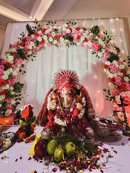 We love decorating for home pujas like Ganesh Chaturthi. Here, we created a beautiful floral arch with pink and white roses around the Ganpati idol, complemented by a soft, illuminated backdrop to make the celebration at home feel extra special and divine.