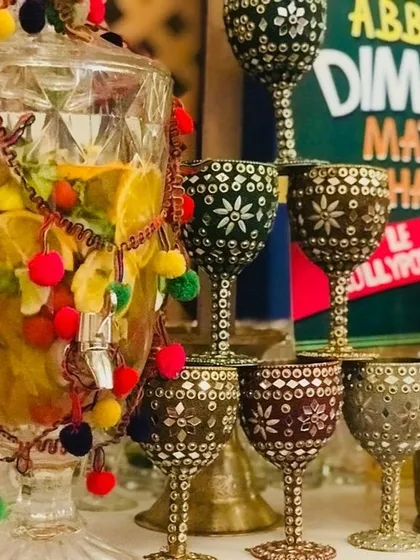 It's all about the details in my Funjabi theme. I use ornate, mirror-work goblets and a large drink dispenser decorated with colorful pom-poms to serve refreshing drinks with a traditional twist.