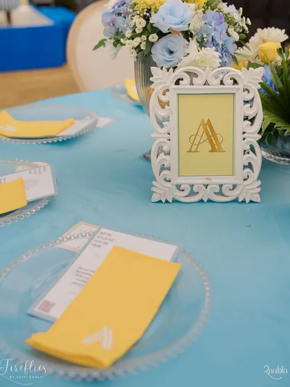 A personalized table setting for the Jodhpur-themed Haldi, with a monogrammed frame and custom-printed napkin.