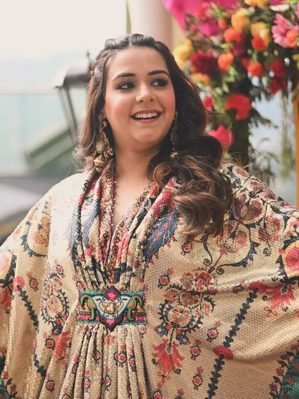 The joy of a bride-to-be. The flowing silhouette of the kaftan was perfect for the relaxed, happy vibe of the mehendi function, allowing her to move freely and enjoy the celebration.