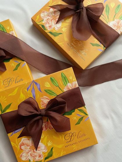 A box of 16 assorted truffles, beautifully packaged with a rich brown ribbon. It's a perfect gift for any occasion, from birthdays to anniversaries.