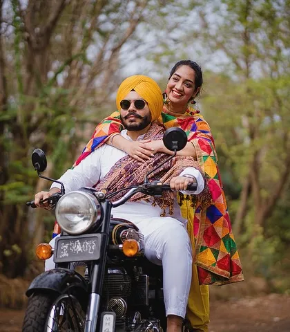 We love capturing the vibrant energy of different cultures. This fun shot from Kanwal and Avneet's pre-wedding session in Punjab, with the classic bullet and colorful phulkari, is full of life and personality.