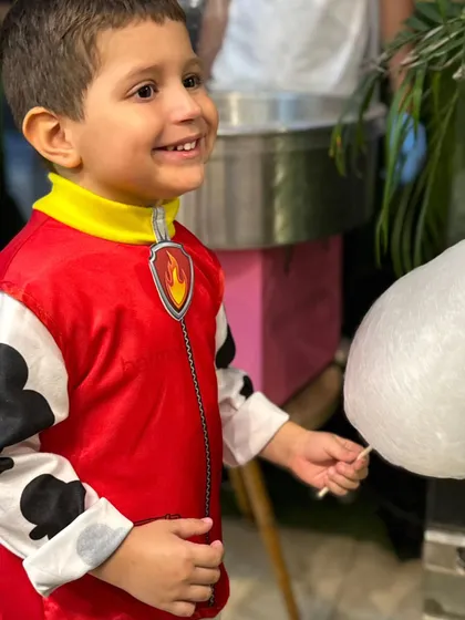 A happy smile from a little one enjoying his freshly made cotton candy.