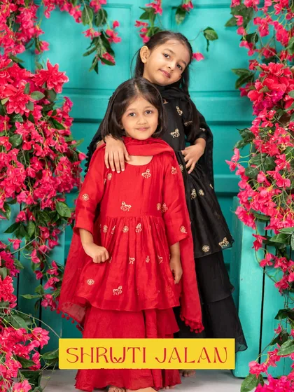 A bold and beautiful look for a little fashionista. This sister duo in red and black sharara sets shows how you can coordinate colors for a striking effect.