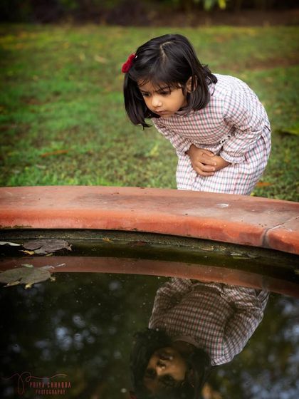 A moment of quiet curiosity as a little girl looks at her reflection in the water. Outdoor shoots are full of opportunities for unique and story-driven photos.