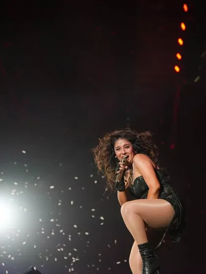 Sunidhi working the stage in Mumbai, with confetti falling around her.