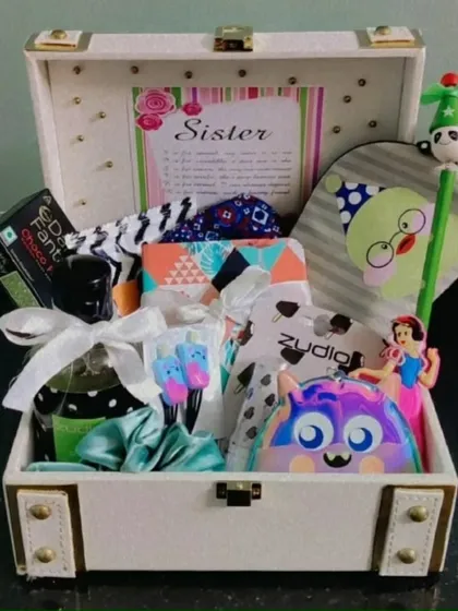 Another "Sis-star" hamper in a white trunk. It's filled with a unique collection of gifts to surprise and delight a special sister.