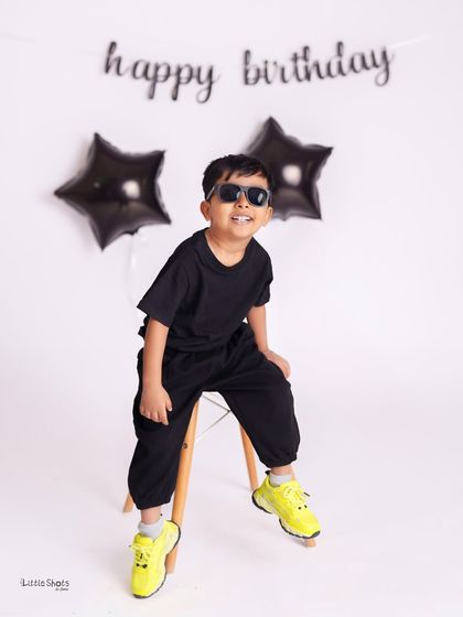 This little guy has so much style and attitude! His cool pose, sunglasses, and bright yellow shoes make this a fun and modern birthday portrait.
