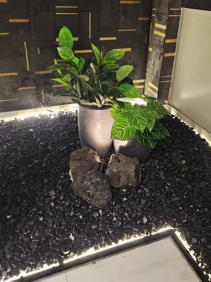 Don't forget the small, unused corners in your home. I created this modern indoor pebble landscape with artificial plants and integrated lighting to transform the empty space under a staircase into a stylish feature.