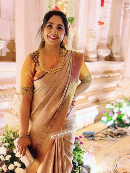 This client is ready for a wedding reception in a beautiful beige saree. I designed a contrasting orange blouse with heavy embroidery on the sleeves.