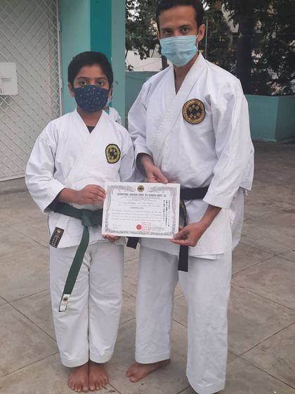 A young karateka, Atharv, receiving his kyu grading certificate. I congratulate him on this achievement and encourage his continued practice in traditional Okinawan karate.