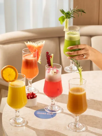A beautiful array of fresh-pressed juices. The vibrant colors are arranged to be visually appealing and showcase the healthy, natural ingredients.