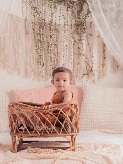 This little one is celebrating his first birthday in our boho bedroom setup. The natural textures of macrame and rattan create a warm and stylish backdrop.