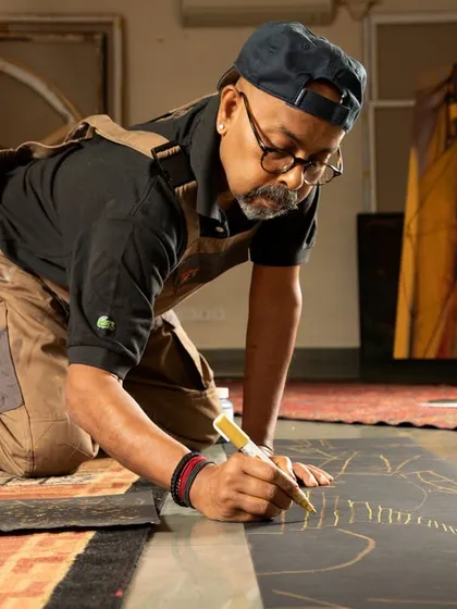 Another birthday post for Paresh Maity, showing him at work in his studio, sketching on the floor.