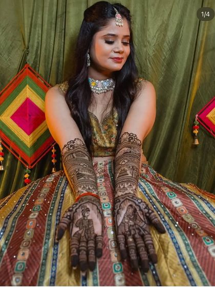 Another shot of the client's mehendi and her vibrant lehenga, a perfect combination for a pre-wedding celebration.