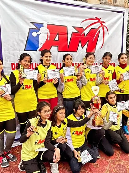 Our girls' team showing off their trophies and certificates. We have a strong and successful girls' basketball program.