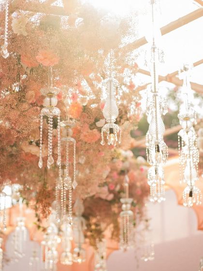 Delicate crystal hangings catch the sunlight, adding a touch of sparkle and magic to the floral decor.