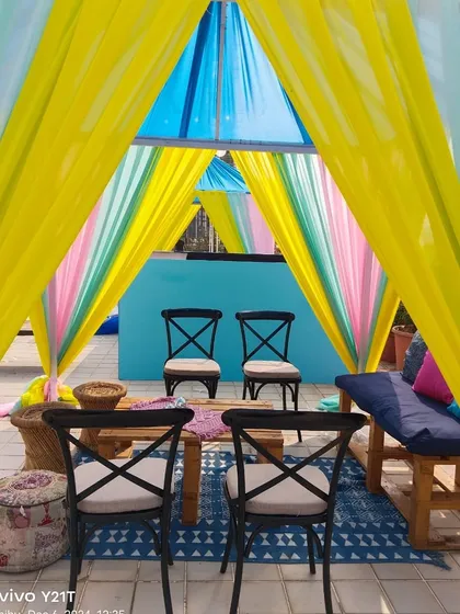 A closer look at the seating inside the cabana on a terrace. We use a mix of chairs and floor cushions to create a comfortable and bohemian vibe for your guests.