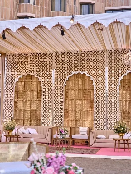 For this outdoor lounge, I designed a beautiful canopy with a traditional jali backdrop, elegant drapes, and crystal chandeliers, creating a space that felt both royal and romantic.