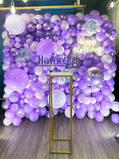 A full wall of lavender and purple balloons. This creates an immersive and high-impact photo opportunity.