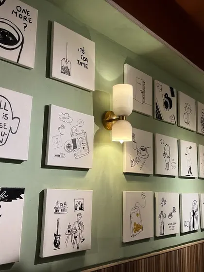 Another view of the illustration gallery wall. This kind of installation adds a lot of personality and charm to a cafe space.