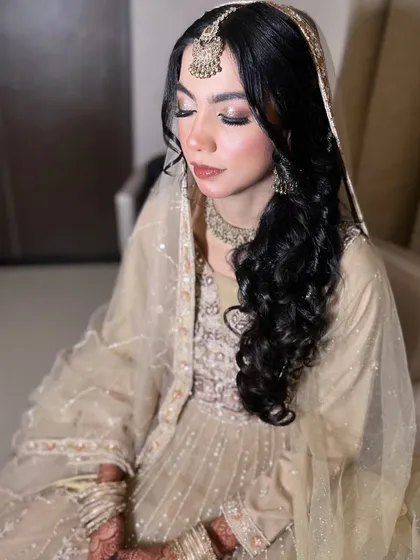 A candid shot showing the soft, shimmery eye makeup that complements her delicate jewellery.