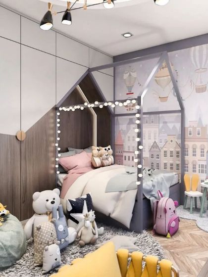 A cozy kid's room featuring a house-frame bed with fairy lights and playful wallpaper. The design creates a magical and inviting atmosphere for a child.