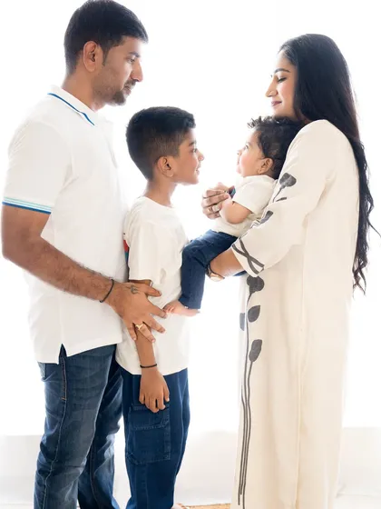 A beautiful profile shot of the family interacting. This candid style of photography captures the natural connections and love between family members.