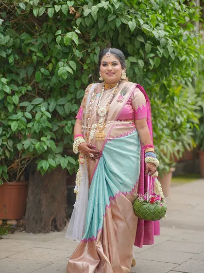 A full-length shot of the mom-to-be, showcasing her entire look with the custom floral jewellery and matching green woven basket.