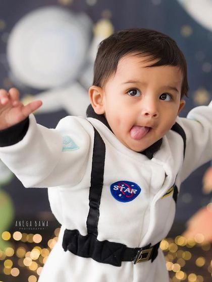 A cheeky astronaut reporting for duty. This little one's playful expression is out of this world! Themed shoots are a great way to capture your child's imagination.
