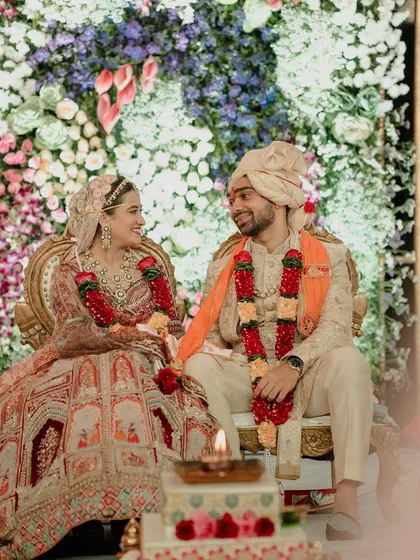 A beautiful moment during the wedding ceremony, with the couple sharing a loving glance against a backdrop of flowers.