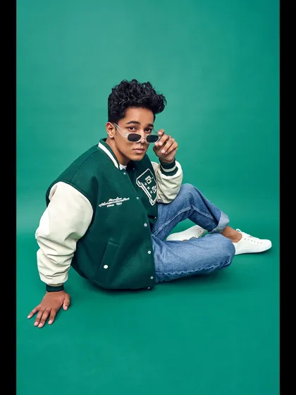 Styling for men is about capturing an attitude. For this model's portfolio, I created a cool, collegiate look with a classic varsity jacket, casual denim, and sleek sunglasses that feels both current and timeless.