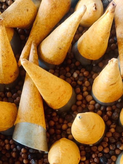 An aerial view of our cornetts, showcasing their uniform shape and the care taken in their preparation. They are a staple of our inventive Indian menu.