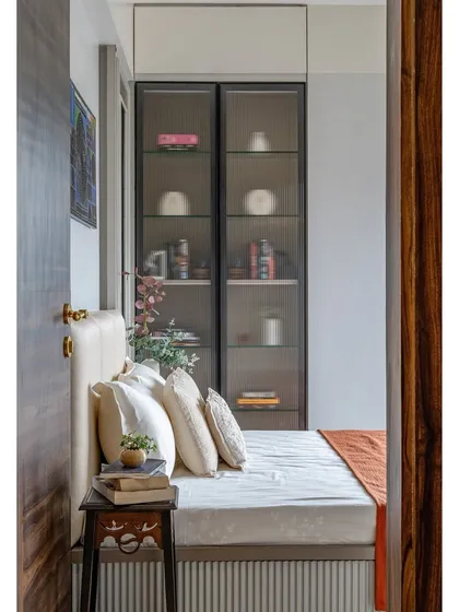 A peek into the guest room from the doorway, offering an inviting glimpse of the comfortable bed and thoughtfully arranged details.