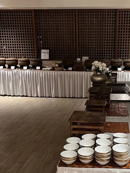 A wide shot of a buffet setup. The clean lines, white linens, and rustic serveware create a look that is both elegant and inviting.