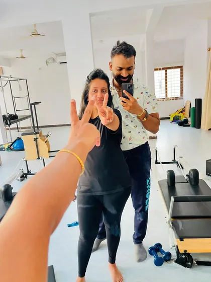 Peace and Pilates! A fun, candid moment captured in the studio mirror.