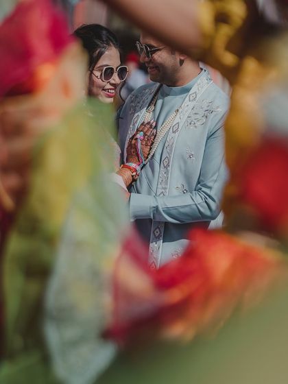 A secret glance between the couple, captured through a colorful foreground. This artistic shot adds a layer of intimacy and creativity.