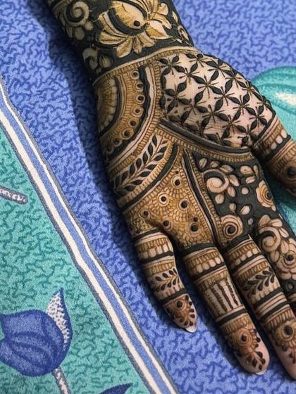 A close-up of a palm with a unique star-like floral pattern, combined with geometric fills.