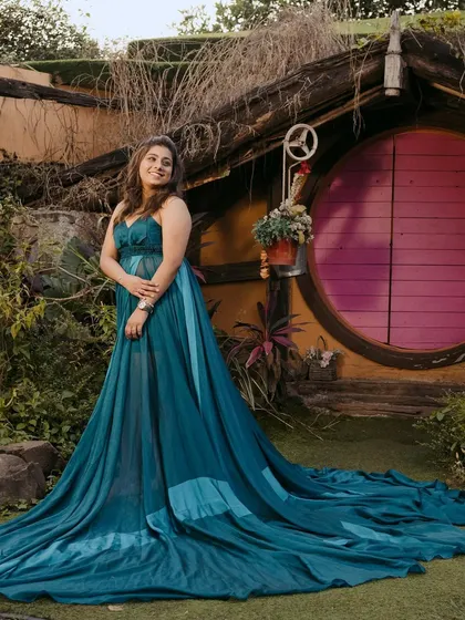 A whimsical shot from the same pre-wedding shoot. The glamorous makeup and hairstyle work beautifully with the dramatic trail of her gown and the unique setting.