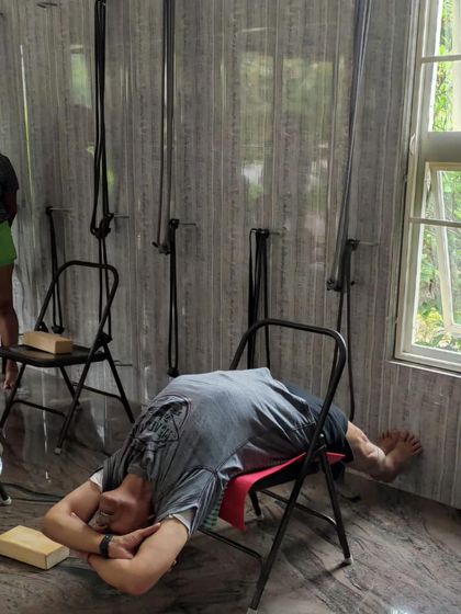 A relaxing backbend on a chair.