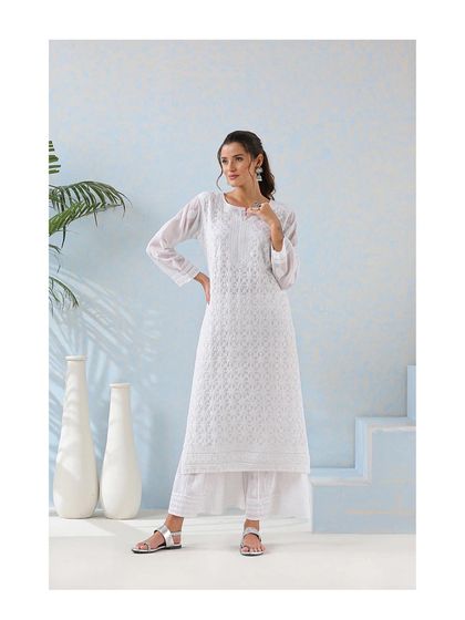 The timeless elegance of an all-white chikankari kurta and palazzo set. This is a serene and sophisticated option for a Haldi ceremony or a pre-wedding family lunch.