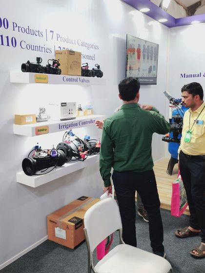 Our team member explaining the different types of control valves and irrigation controllers to a visitor at our booth.