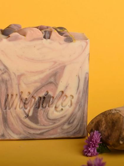 A close-up of the Sandalwood and Vetiver soap, highlighting its rich texture and the small soap chunks on top. The harmonious blend of essential oils makes it perfect for a calming festive bath.