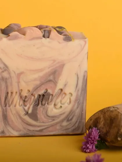 A close-up of the Sandalwood and Vetiver soap, showing its rich texture and color. The scent is a harmonious blend perfect for the festive season.