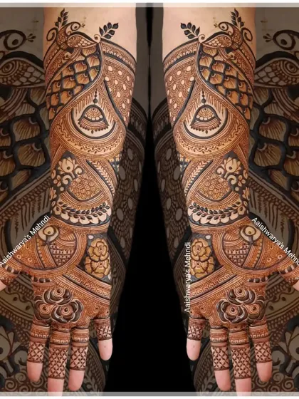 A breathtakingly intricate bridal design featuring swirling peacock and jhumka motifs. The density and flow of this pattern create a truly show-stopping effect.